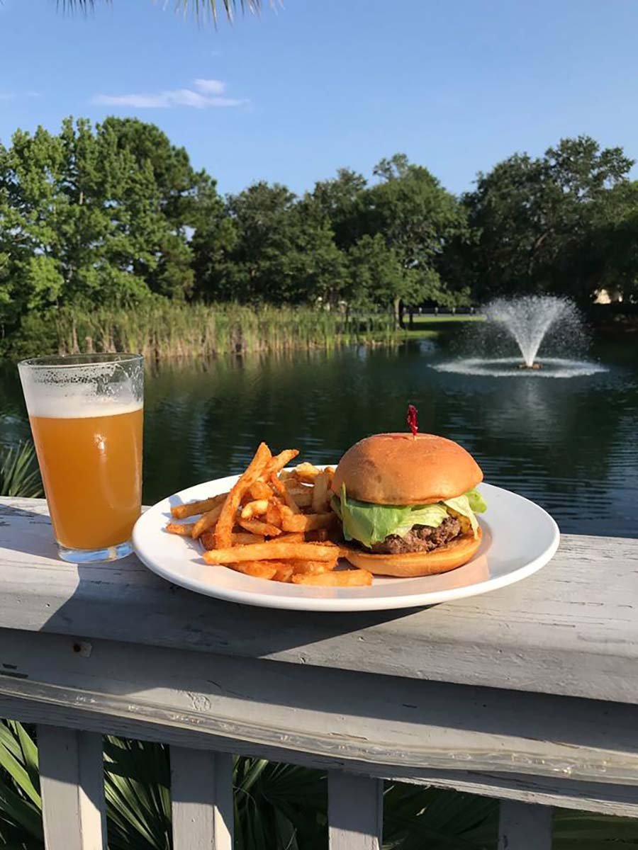 Hamburger and fries outside on the deck