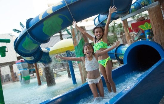 Girls at the end of a big slide at Ocean Reef Resort